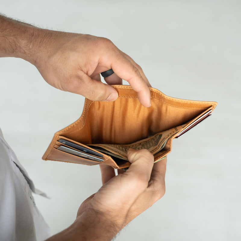 Man holding Titus Trifold Wallet by Elevate