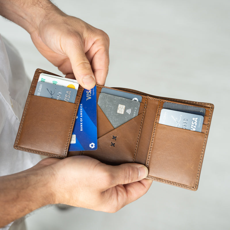 Man holding Titus Trifold Wallet by Elevate