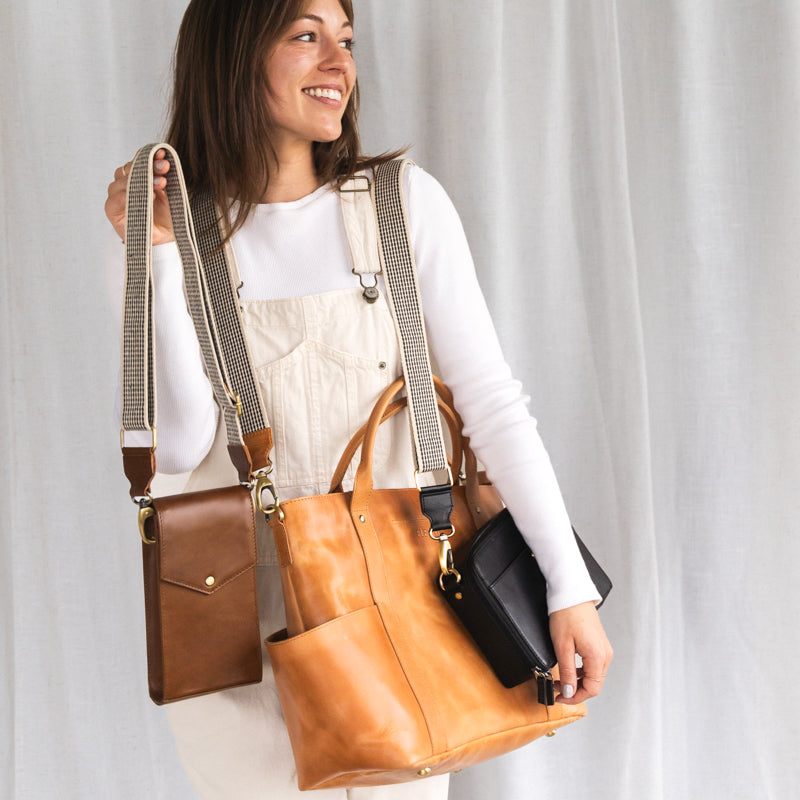 Woman holding several bags with Woven Strap by Elevate